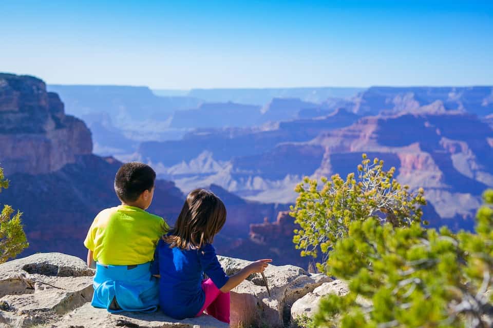 Two children look across a canyon
